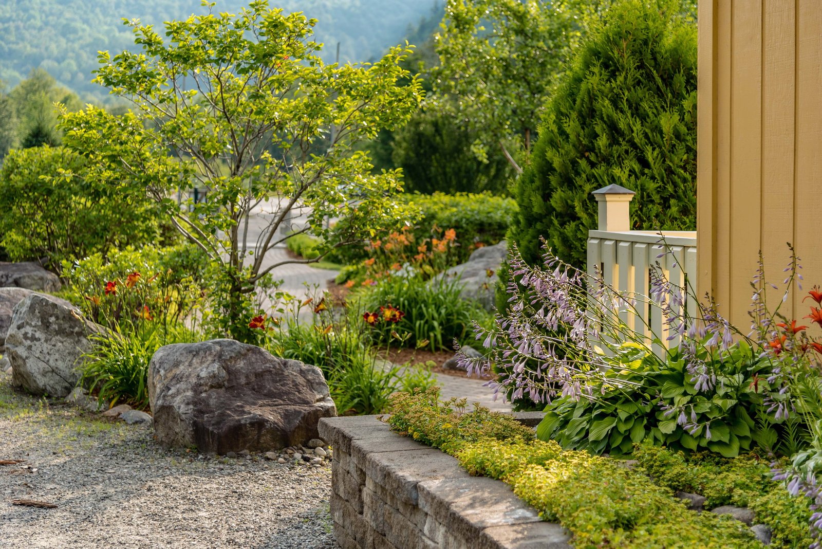 Stone wall hardscaping and landscaping in yard
